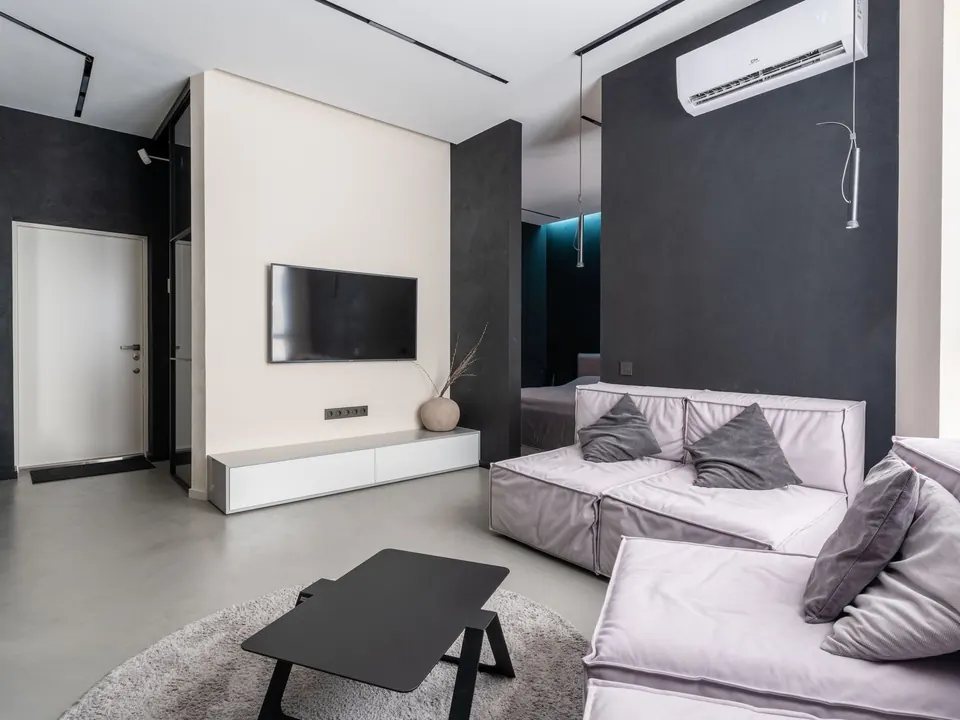 Living room with a ductless mini-split indoor unit above the TV wall
