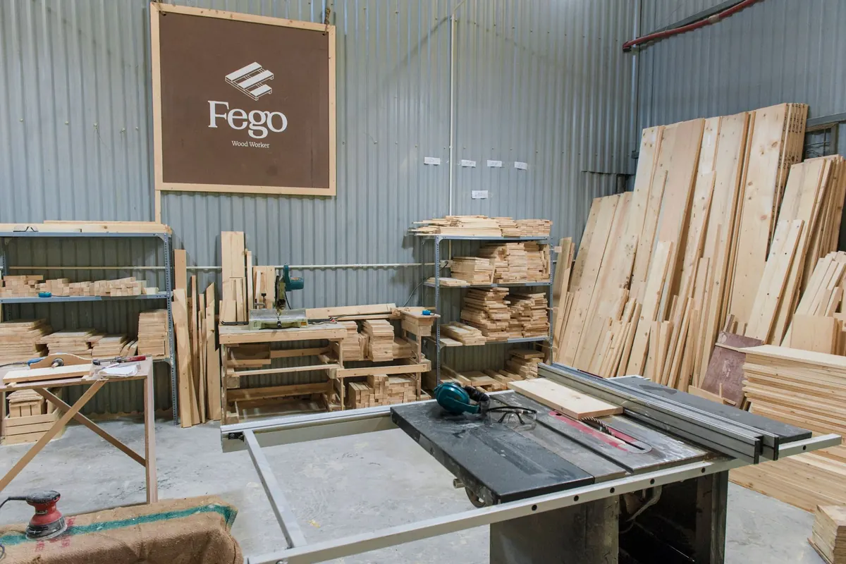 Detached woodworking workshop with benches and lumber